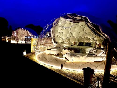 a bed in a tent with lights on it at Deerstone Glamping-Pinhaw Beacon dome Hot tub in Earby