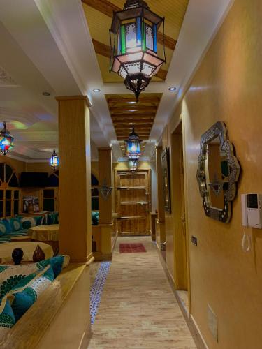 a hallway with a chandelier and a room at DAR EL HACHIMI EL IDRISSI in Ourika