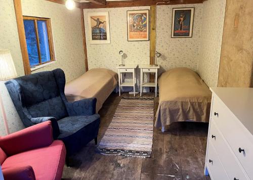 a room with two beds and a couch and a chair at Cozy holiday home in Tranas, Odeshog in Tranås