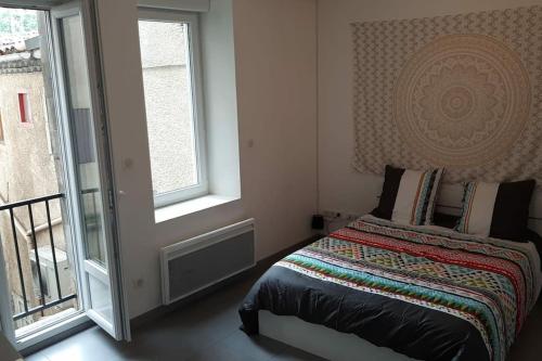 a bedroom with a bed next to a window at studio hyper-centre confortable acces boite a clee parking in Castres