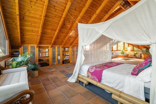 a bedroom with a bed and a wooden ceiling at BARCELONA´S TROPICAL OASIS in Sant Just Desvern