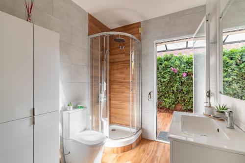 a bathroom with a shower and a toilet and a sink at BARCELONA´S TROPICAL OASIS in Sant Just Desvern