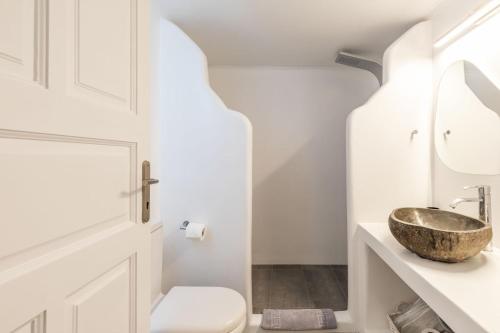 a white bathroom with a sink and a mirror at Mykonian Breeze in Ano Mera