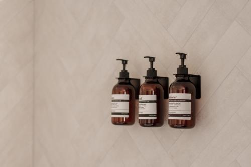 four bottles of soap hanging on a wall at La Stanza del Relax in San Donà di Piave