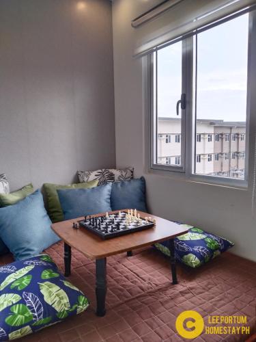a living room with a chess board on a table at F524 Place at SMDC Cheer Residences by Lee Portum in Marilao