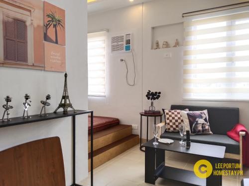 a living room with a couch and a table at F524 Place at SMDC Cheer Residences by Lee Portum in Marilao