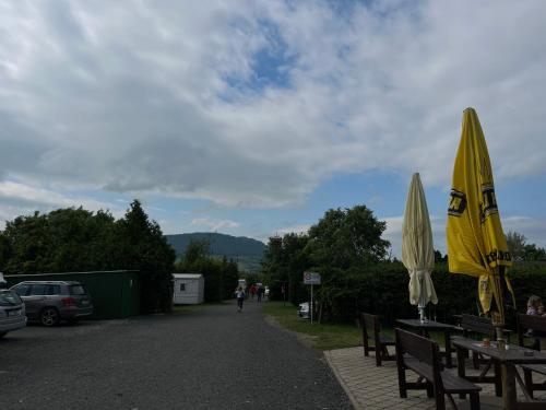 a couple of tables with umbrellas on a road at Autocamp Free Star - Mobilheimy in Strachotín