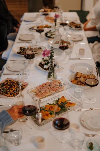 a long table with plates of food on it at Ottmanngut Suite and Breakfast in Merano