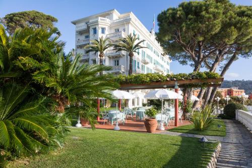 a large white building with a lawn in front of it at Grand Hotel Miramare in Santa Margherita Ligure