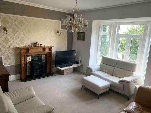 a living room with a couch and a fireplace at Strawberry Fields - CENTRAL TORQUAY in Torquay
