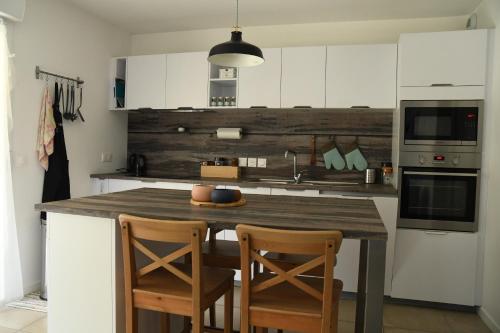 - une cuisine avec un comptoir en bois dans l'établissement Appartement T3 (plain-pied) et son jardin privatif clos à Vieux Boucau, à Vieux-Boucau-les-Bains