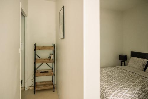a bedroom with a bed and a ladder next to a wall at Le Silène in Rodez