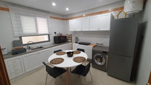 a kitchen with a white table and a white refrigerator at Tunis medina in Tunis