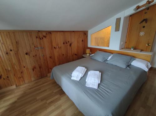 a bedroom with a large bed with two towels on it at Naasara-Cerler in Cerler