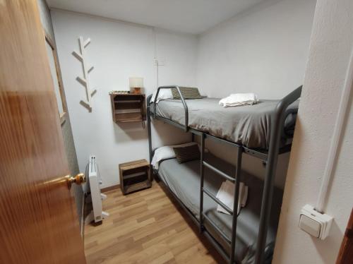 a room with two bunk beds and a door at Naasara-Cerler in Cerler