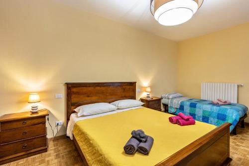 a bedroom with two beds with towels on the bed at Cascina Raperonzolo in Lonato del Garda