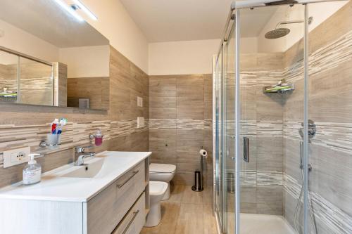 a bathroom with a shower and a sink and a toilet at Cascina Raperonzolo in Lonato del Garda