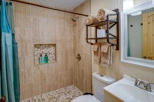 a bathroom with a toilet and a sink and a shower at Cozy 3 Oaks Cottage in Gulfport Close to Beach! in Gulfport