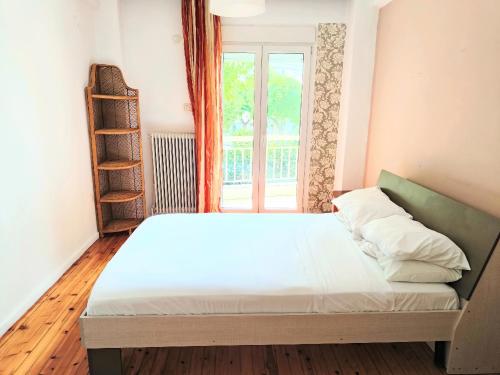 a bed in a room with a window at 3BR Spacious City Center in Thessaloniki