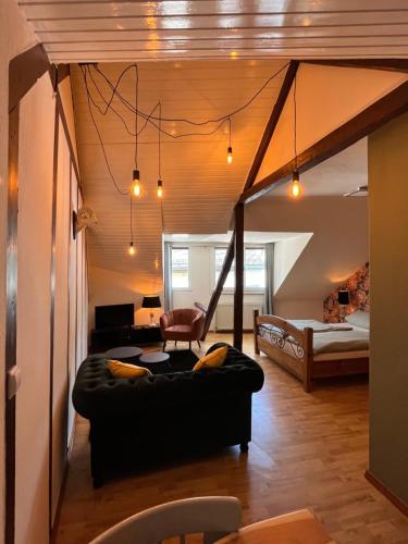 a living room with a couch and a bed at Meyver Cochem Centrum. in Cochem