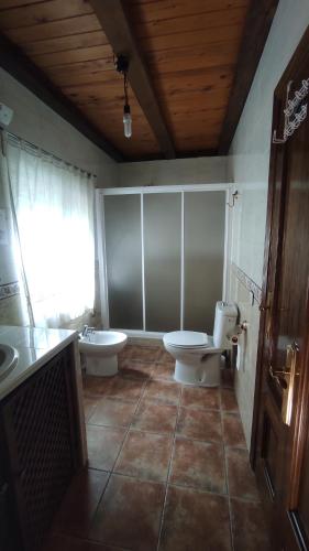 a bathroom with a toilet and a sink and a toilet istg at Los rosales in Burunchel