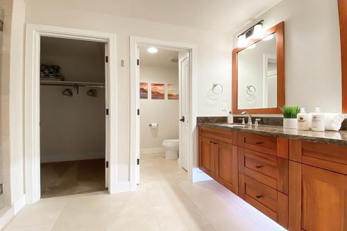 a bathroom with a sink and a toilet at Pili Mai 13C in Koloa