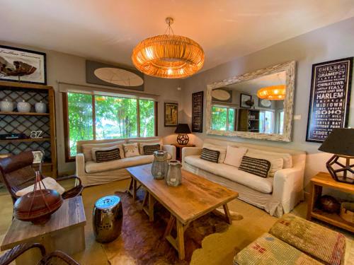 a living room with couches and a table at Xeliter Balcones del Atlantico - Las Terrenas in Las Terrenas