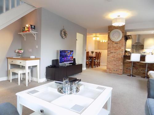 a living room with a white table and a living room at Double Award Winning, Stunning 1700's Grd 2 listed cottage near Stonehenge - Elegantly Refurbished Throughout in Amesbury