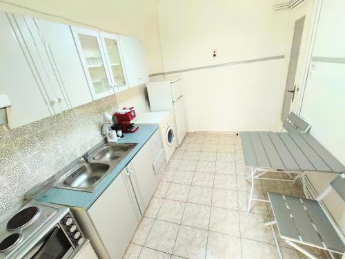 a kitchen with a sink and a washing machine at 3BR Spacious City Center in Thessaloniki