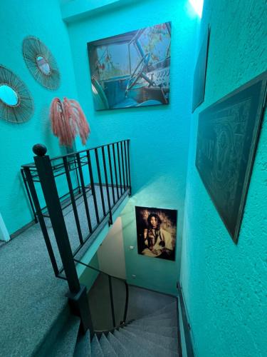 a blue room with a staircase with a picture on the wall at Meyver Cochem Centrum. in Cochem