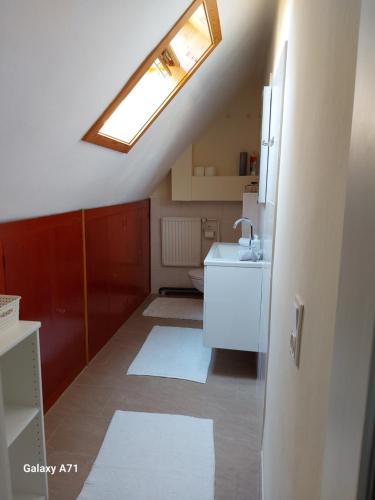 a small bathroom with a sink and a skylight at Ferienhaus Käthe in Klagenfurt