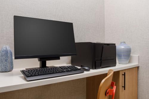 a computer monitor sitting on top of a desk at Hyatt Place across from Universal Orlando Resort in Orlando