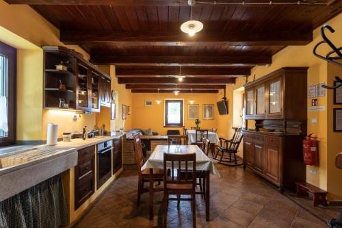 a kitchen with a table and a dining room at Tinčeva hiša in Kanal