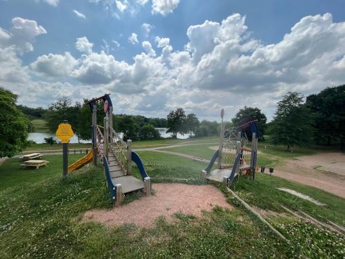 a group of playground equipment in a park at Résidence du Lac - Proximité Le PAL in Bourbon-Lancy