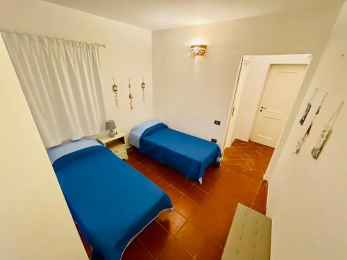 a small room with two beds and a table at Piazza ginestre porto rotondo in Porto Rotondo