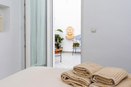 a stack of towels sitting on a bed in a room at Casa Bonita in Almería