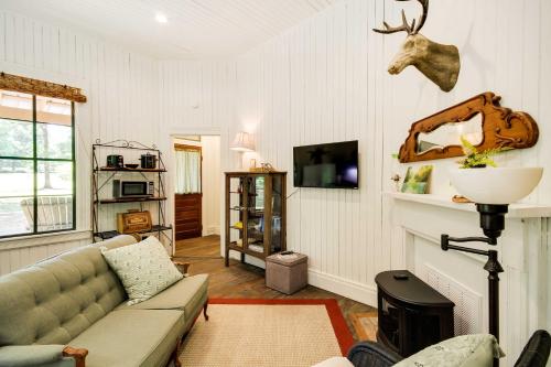 a living room with a couch and a fireplace at Historic Nature Retreat in McComb with River Access in McComb