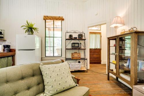 a living room with a couch and a refrigerator at Historic Nature Retreat in McComb with River Access in McComb