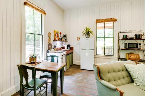 a living room with a table and a kitchen at Historic Nature Retreat in McComb with River Access in McComb