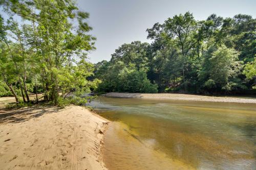 a sandy beach with trees and a river at Historic Nature Retreat in McComb with River Access in McComb