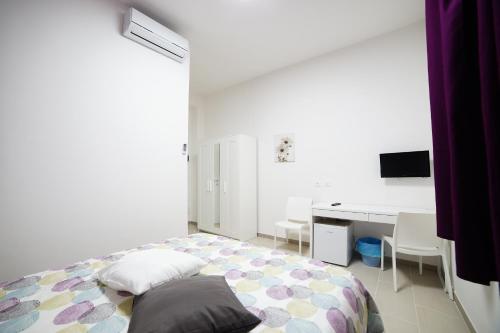 Letto o letti in una camera di Affittacamere Arcobaleno