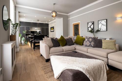 a living room with a couch and a table at Stylish Central Apartment with Parking & Lift in Bury Saint Edmunds