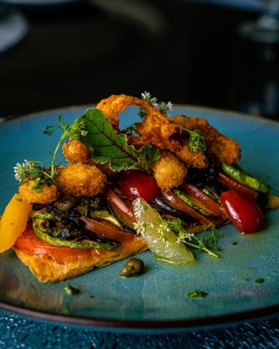 a blue plate of food with vegetables on it at Waves Aqua Resort in Kenitra