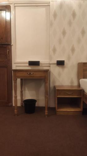 a room with a table and a whiteboard on the wall at the 1959 house in Shillong