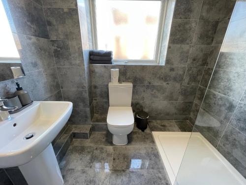a bathroom with a toilet and a sink at Hosted By Ryan - 1 Bedroom Apartment in Liverpool