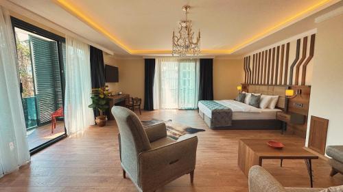 a large living room with a bed and a couch at BİLİRİS HOTEL in Trabzon