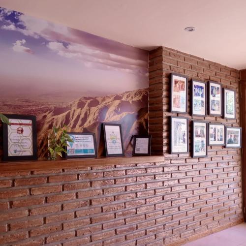 a brick wall with a mural of the grand canyon at Hotel Valle Del Sol in Merlo