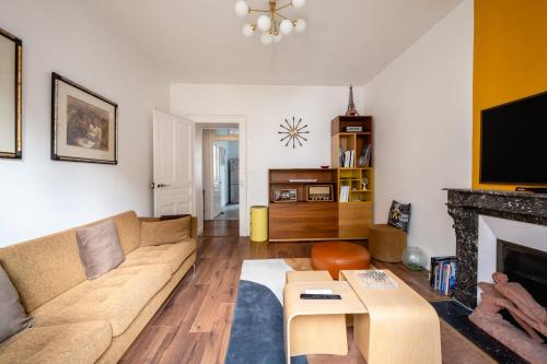 un salon avec un canapé et une cheminée dans l'établissement Le Cosy d'Aléry - Charming 3 room apartment near downtown, à Annecy