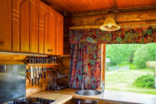 a kitchen with a sink and a window in a cabin at Luha Talu 