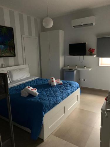 a bedroom with a bed with towels on it at i girasoli srls in Bari